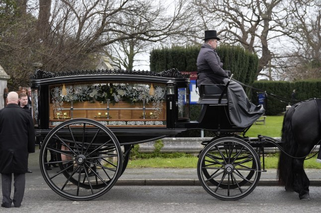 A horse-drawn carriage carrying the coffin of The Vivienne arrives at a church in Bodelwyddan, Denbighshire for their funeral. The TV star, real name James Lee Williams, who shot to fame after winning the first series of RuPaul's Drag Race UK, died at the age of 32 earlier this month. Picture date: Monday January 27, 2025. PA Photo. See PA story FUNERAL Vivienne. Photo credit should read: Danny Lawson/PA Wire