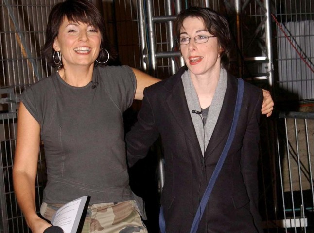 TV presenter Sue Perkins leaves the Big Brother house at Elstree Studios in Hertfordshire, with show host Davina McCall, becoming the third person to be evicted from Celebrity Big Brother 2002.