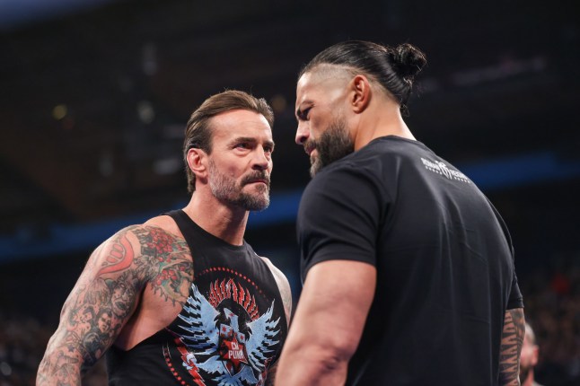ROSEMONT, ILLINOIS - APRIL 4: CM Punk and Roman Reigns face off during SmackDown at Allstate Arena on April 4, 2025 in Rosemont, Illinois. (Photo by Eric Johnson/WWE via Getty Images)