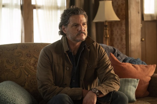Pedro Pascal in The Last of Us season 2 sits on a couch