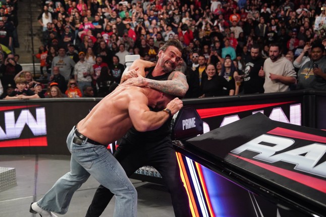 MINNEAPOLIS, MINNESOTA - APRIL 7: CM Punk attacks Seth Rollins outside the ring during Monday Night RAW at Target Center on April 7, 2025 in Minneapolis, Minnesota. (Photo by Rich Freeda/WWE via Getty Images)