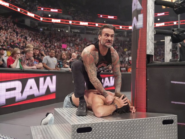 MINNEAPOLIS, MINNESOTA - APRIL 7: CM Punk attacks Seth Rollins during Monday Night RAW at Target Center on April 7, 2025 in Minneapolis, Minnesota. (Photo by Craig Melvin/WWE via Getty Images)