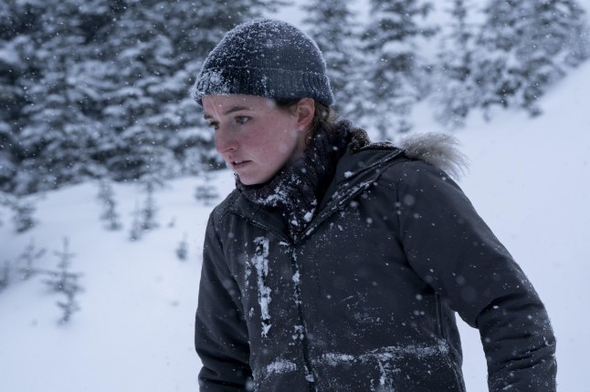 Kaitlyn Dever as Abby in The Last of Us standing outside in a snowy terrain wearing warm clothing