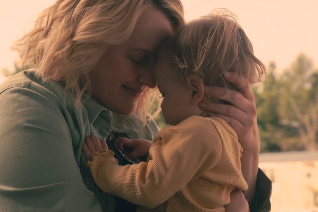 Elizabeth Olson as June hugging her young daughter in The Handmaid's Tale