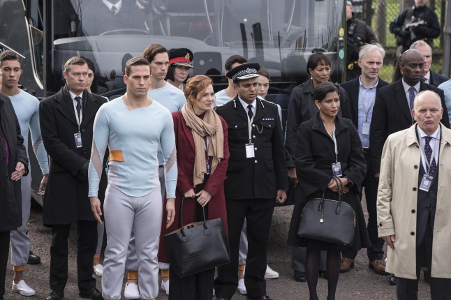 Dino Fetscher as Stanley and Katherine Parkinson as Laura stood among a crowd of people