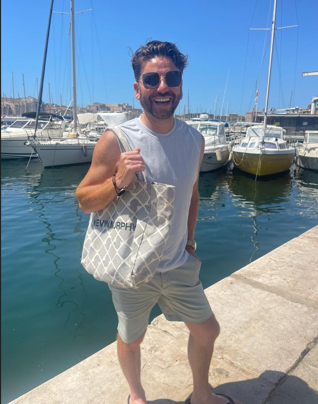 Daniel Lustig Webb in a white-grey get-up on the pier