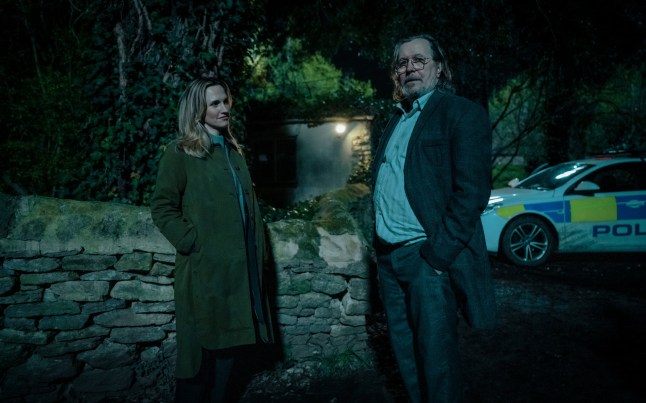 A still of a man and a woman standing together in the dark in Slow Horses