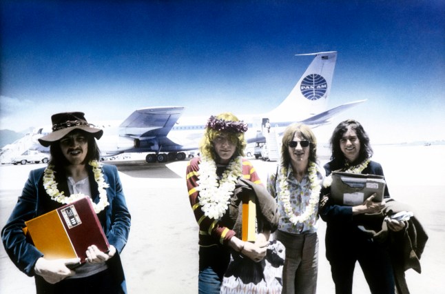 UNITED STATES - MAY 12: HONOLULU Photo of LED ZEPPELIN, L-R: John Bonham, Robert Plant, John Paul Jones, Jimmy Page - group shot, posed - arriving at Honolulu Airport, holding Led Zeppelin II master tapes (Photo by Robert Knight Archive/Redferns)