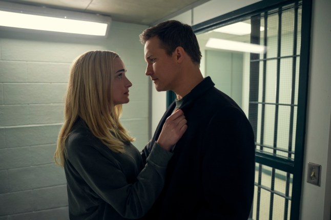 Brianne Howey as Georgia Miller, Scott Porter as Paul embracing each other in prison in Ginny & Georgia