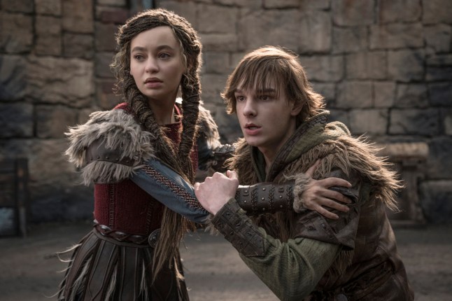Mason Thames and Nico Parker holding each other back in a How To Train Your Dragon scene.