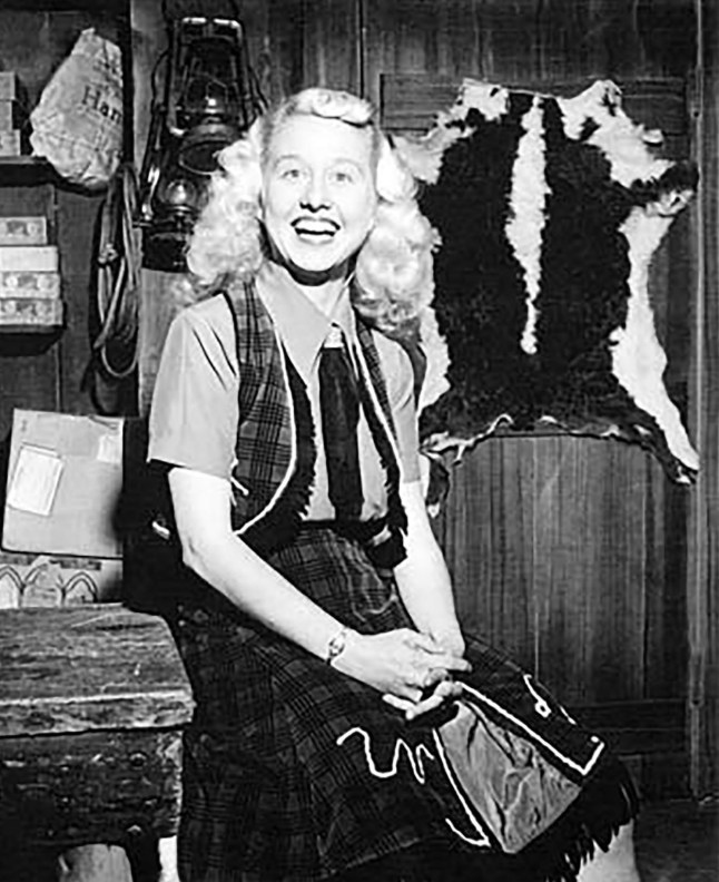 Betsy Gay in black and white smiling to the camera