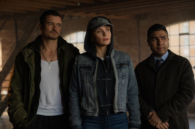 Orlando Bloom as MARLON, Bryce Dallas Howard as KAT, Nick Mohammed as HUGH in DEEP COVER. Credit: Peter Mountain / ?? 2025 COPERTURA PRODUCTIONS LTD. ALL RIGHTS RESERVED.